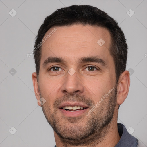 Joyful white young-adult male with short  black hair and brown eyes