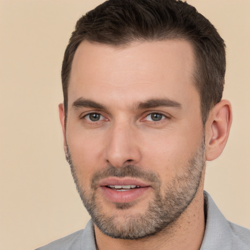 Joyful white young-adult male with short  brown hair and brown eyes