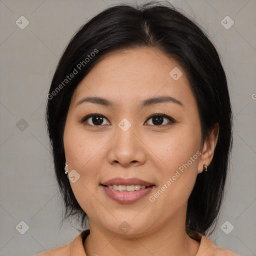 Joyful asian adult female with medium  brown hair and brown eyes