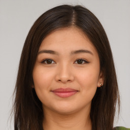 Joyful asian young-adult female with long  brown hair and brown eyes