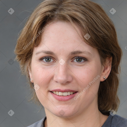 Joyful white adult female with medium  brown hair and blue eyes