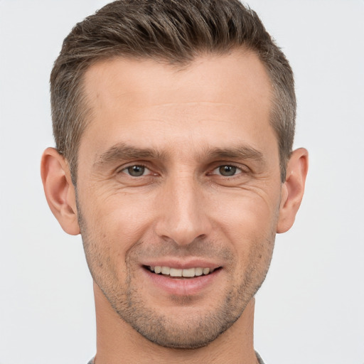 Joyful white adult male with short  brown hair and brown eyes