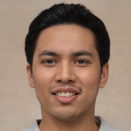 Joyful asian young-adult male with short  black hair and brown eyes