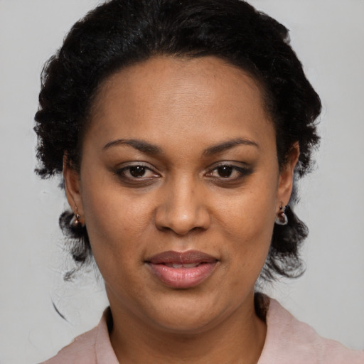 Joyful black adult female with medium  black hair and brown eyes