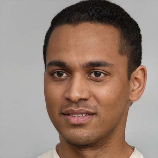 Joyful black young-adult male with short  black hair and brown eyes