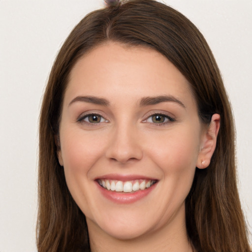 Joyful white young-adult female with long  brown hair and brown eyes