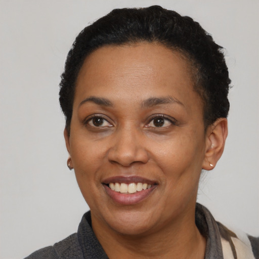 Joyful latino adult female with short  black hair and brown eyes