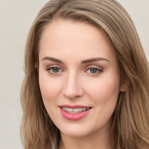 Joyful white young-adult female with long  brown hair and grey eyes