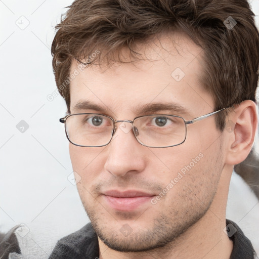 Joyful white adult male with short  brown hair and grey eyes