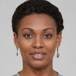 Joyful black young-adult female with short  black hair and brown eyes