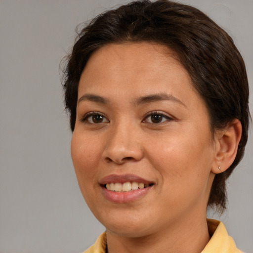 Joyful white young-adult female with medium  brown hair and brown eyes