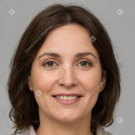 Joyful white adult female with medium  brown hair and grey eyes