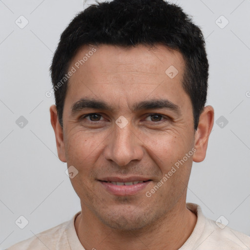 Joyful white young-adult male with short  black hair and brown eyes