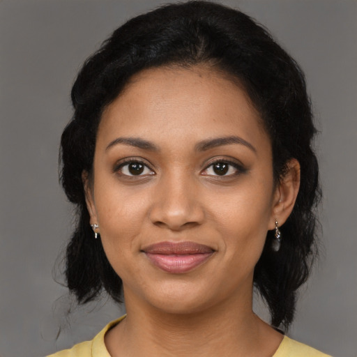 Joyful black young-adult female with medium  black hair and brown eyes