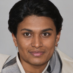 Joyful latino young-adult male with short  brown hair and brown eyes