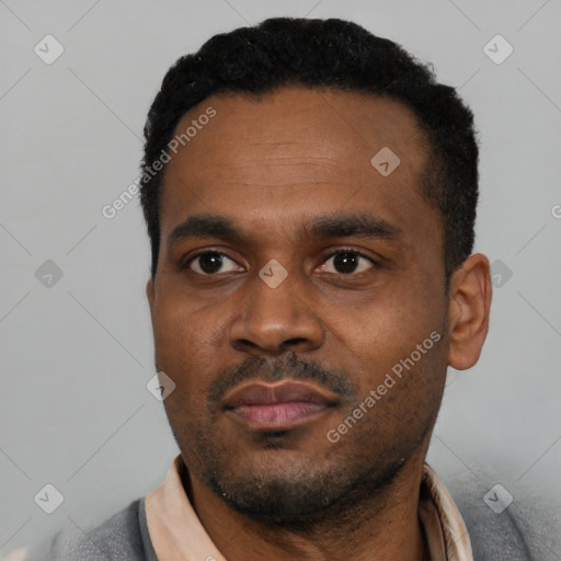 Neutral latino young-adult male with short  black hair and brown eyes