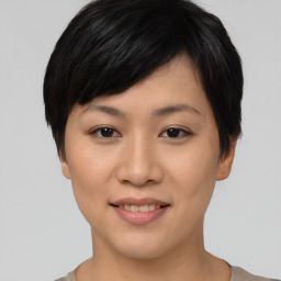 Joyful asian young-adult female with short  black hair and brown eyes