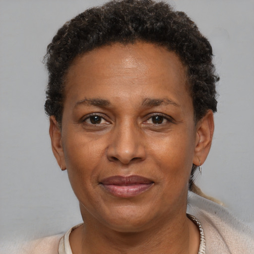 Joyful black adult female with short  brown hair and brown eyes