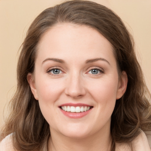 Joyful white young-adult female with long  brown hair and green eyes