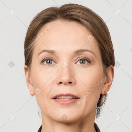 Joyful white adult female with medium  brown hair and grey eyes