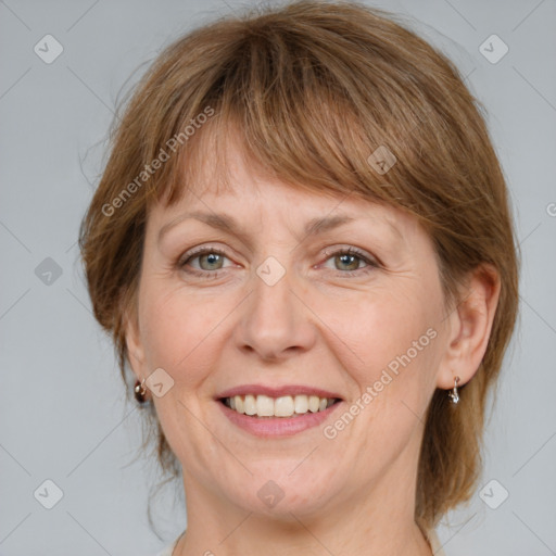 Joyful white adult female with medium  brown hair and grey eyes