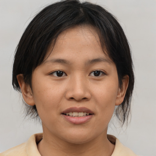 Joyful asian young-adult female with medium  brown hair and brown eyes