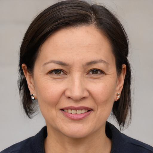 Joyful white adult female with medium  brown hair and brown eyes