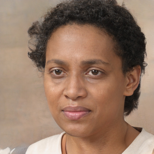 Joyful black adult female with short  brown hair and brown eyes
