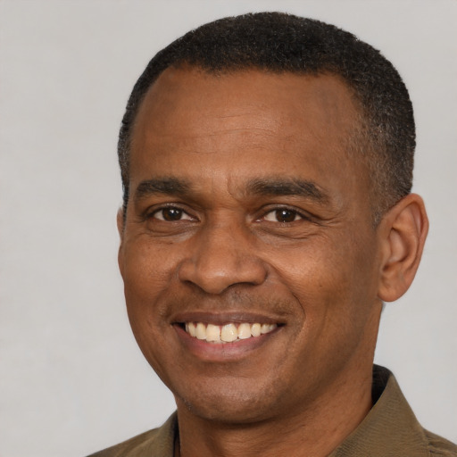 Joyful latino adult male with short  black hair and brown eyes