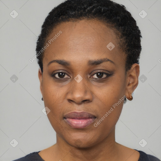 Joyful black young-adult female with short  black hair and brown eyes