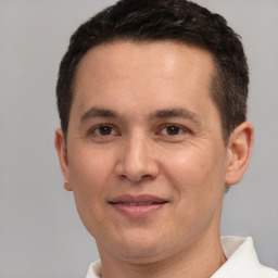 Joyful white adult male with short  brown hair and brown eyes