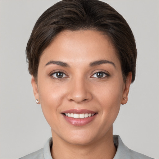 Joyful white young-adult female with short  brown hair and brown eyes