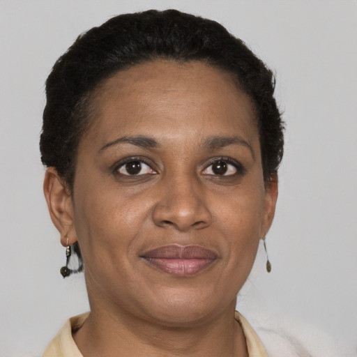 Joyful black adult female with short  brown hair and brown eyes