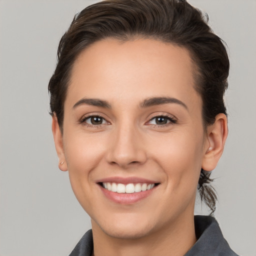 Joyful white young-adult female with short  brown hair and brown eyes