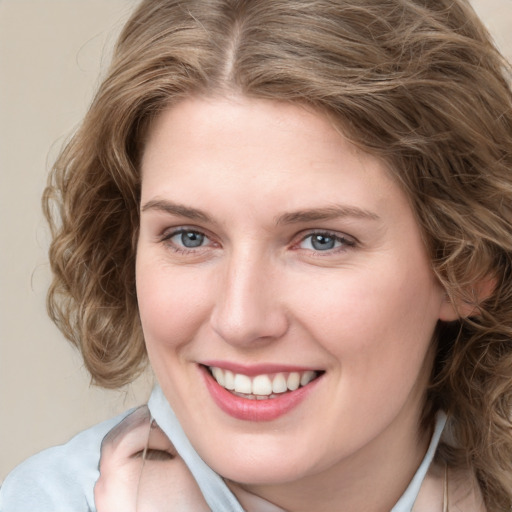 Joyful white young-adult female with medium  brown hair and blue eyes