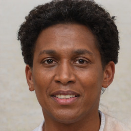 Joyful black adult male with short  brown hair and brown eyes