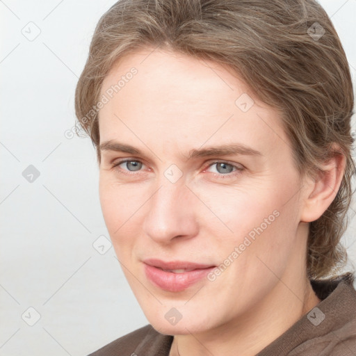 Joyful white young-adult female with medium  brown hair and blue eyes