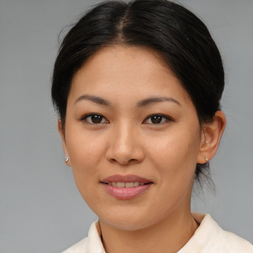 Joyful asian young-adult female with medium  brown hair and brown eyes