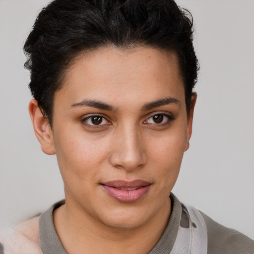 Joyful latino young-adult female with short  brown hair and brown eyes