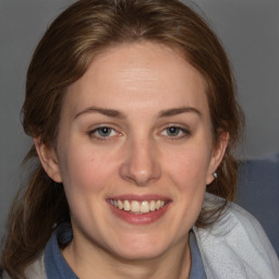 Joyful white young-adult female with medium  brown hair and blue eyes