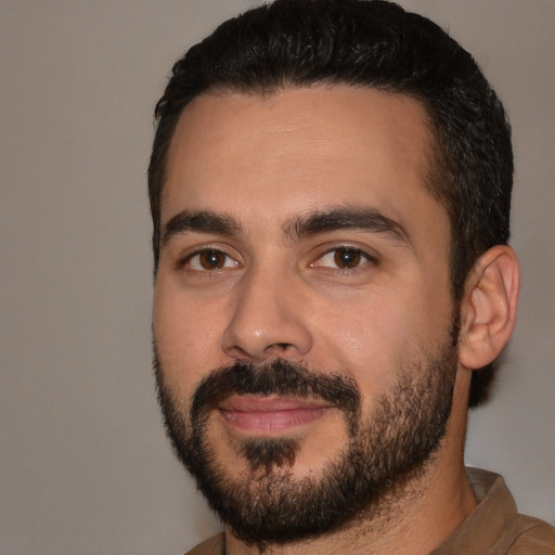 Joyful white young-adult male with short  black hair and brown eyes