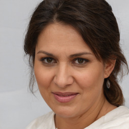 Joyful white adult female with medium  brown hair and brown eyes