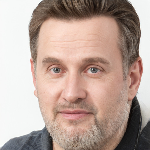 Joyful white adult male with short  brown hair and grey eyes