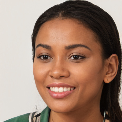 Joyful latino young-adult female with long  black hair and brown eyes