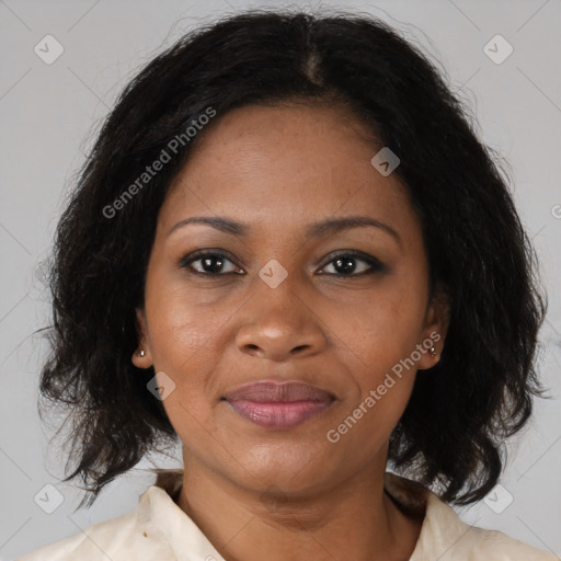 Joyful black adult female with medium  brown hair and brown eyes