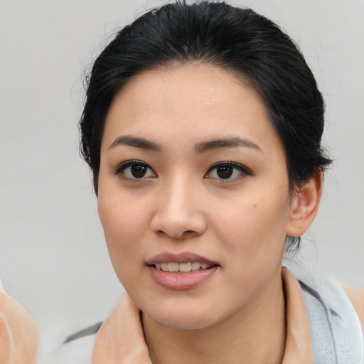 Joyful asian young-adult female with medium  black hair and brown eyes