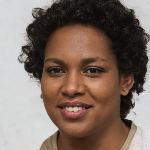 Joyful black young-adult female with short  brown hair and brown eyes