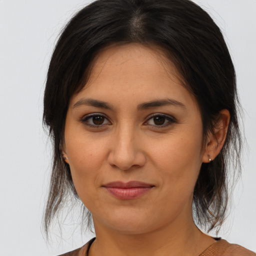 Joyful latino young-adult female with medium  brown hair and brown eyes