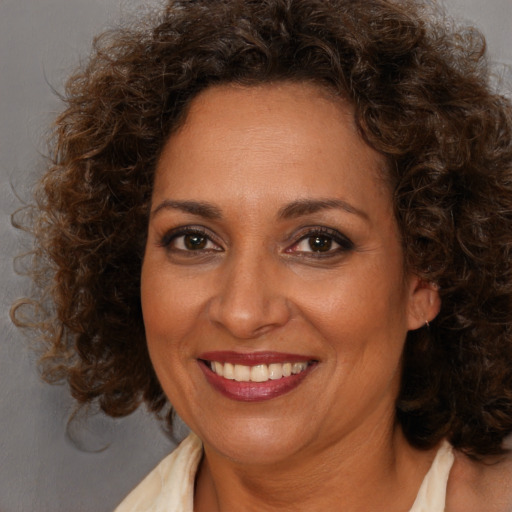 Joyful white adult female with medium  brown hair and brown eyes