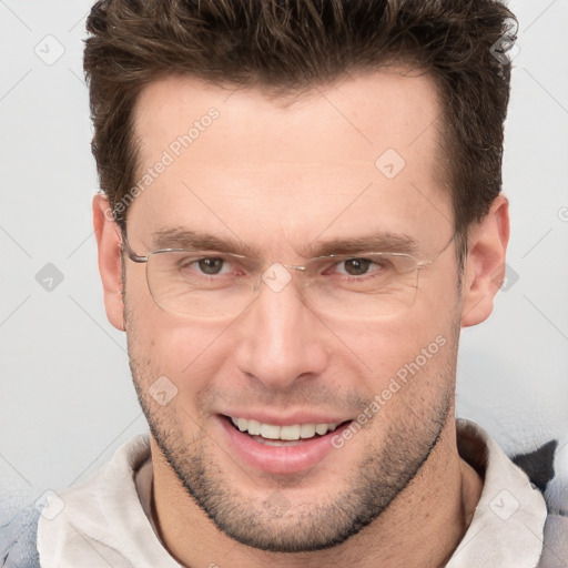 Joyful white adult male with short  brown hair and brown eyes